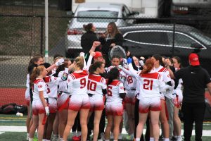 The East Islip Girls Flag Football team huddles up.